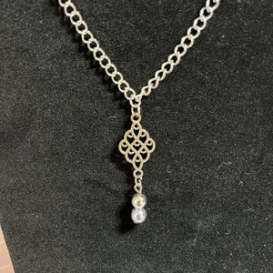 Silver scrollwork necklace with matching drop earrings