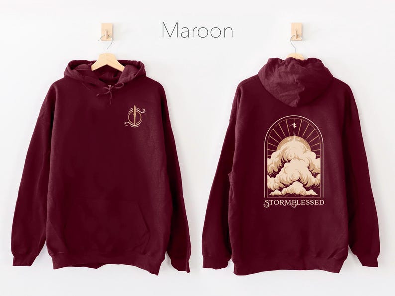 May include: A maroon hoodie with a graphic of a stylized cloud with the text "STORMBLESSED" on the back. The front of the hoodie has a small graphic of a sword.