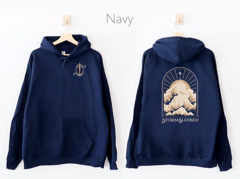May include: Navy blue hooded sweatshirt with a graphic of a stylized cloud formation and the text "STORMBLESSED" on the back. The front of the sweatshirt has a small graphic of a sword.