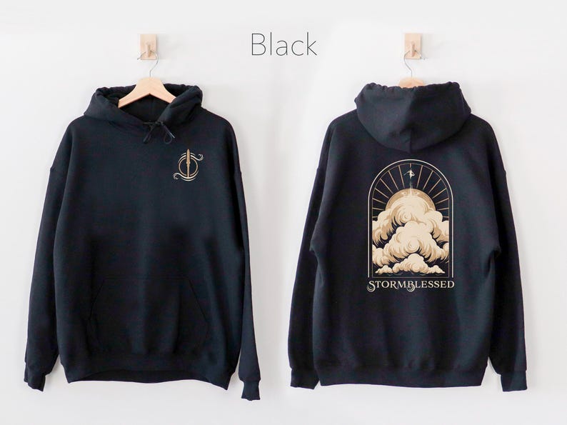 May include: Black hoodie with a gold graphic of a cloud and the text "STORMBLESSED" on the back. The front of the hoodie has a gold graphic of a sword.