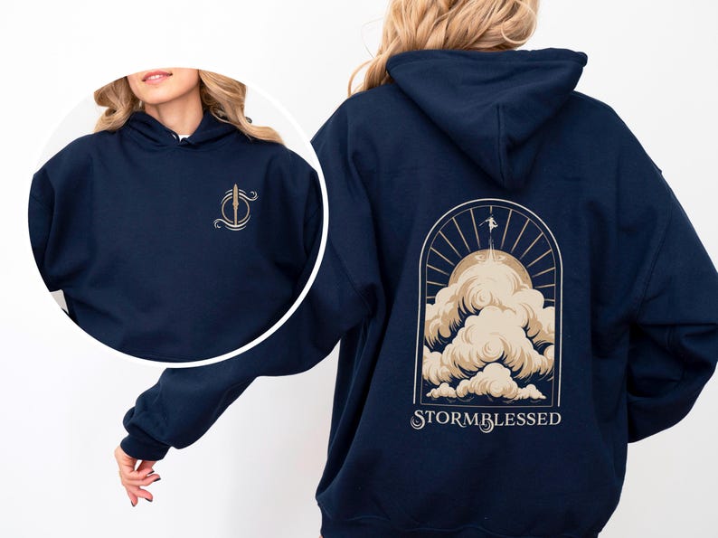 May include: A navy blue hoodie with a graphic of a sun and clouds on the back. The text "STORMBLESSED" is printed below the graphic.