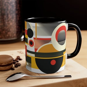 May include: Black coffee mug with a geometric design featuring circles in shades of yellow, red, black, and white.