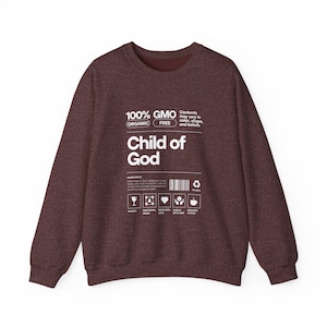 May include: A maroon sweatshirt with a white graphic design that reads "100% GMO FREE ORGANIC Child of God". The graphic is styled like a product label with icons and text.