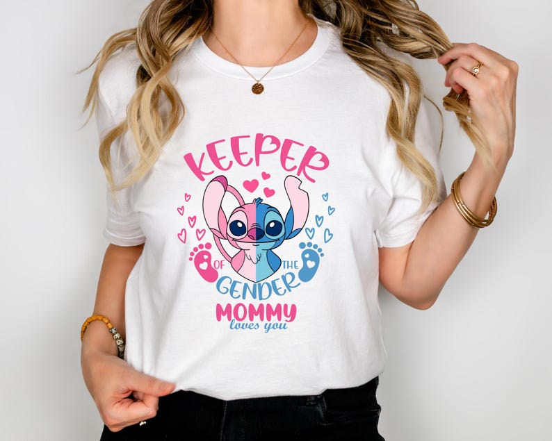 May include: White t-shirt with a pink and blue Stitch character holding a pink and blue baby foot print. The text on the shirt reads "Keeper of the Gender Mommy loves you".