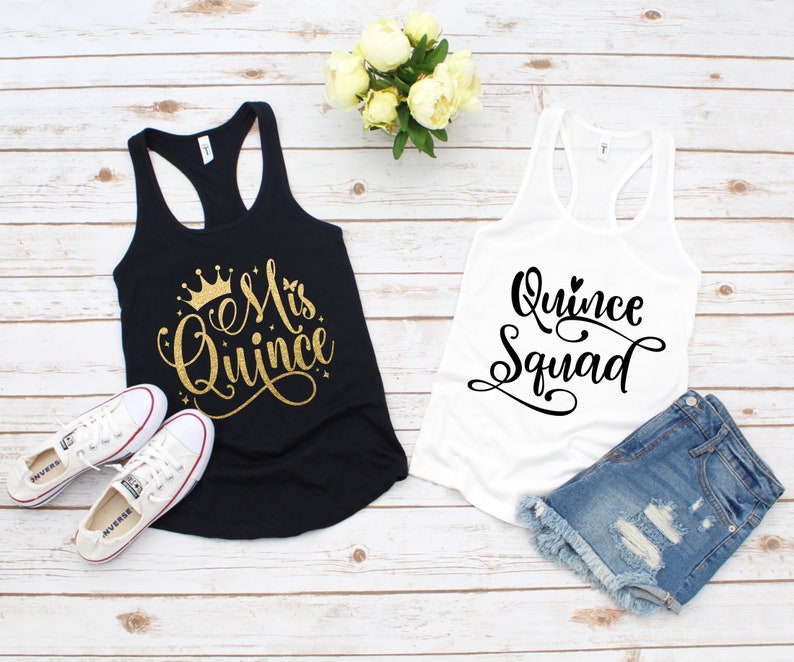 May include: Two tank tops, one black and one white, with text on the front. The black tank top says "Mis Quince" in gold glitter with a crown above the text. The white tank top says "Quince Squad" in black.