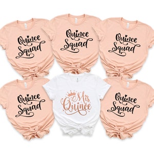 May include: Five t-shirts with the text "Quince Squad" in black script on a peach background. One white t-shirt with the text "Mis Quince" in rose gold script with a crown above the text.