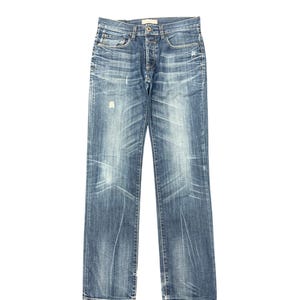 May include: Blue denim jeans with a button fly and distressed details. The jeans have a classic five-pocket design and a straight leg fit. The denim has a faded wash with subtle whiskering and light distressing on the front.