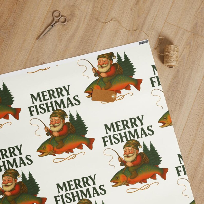 May include: White wrapping paper with a repeating pattern of Santa Claus riding a fish, with the text "MERRY FISHMAS". A pair of scissors and twine are on the wooden surface.