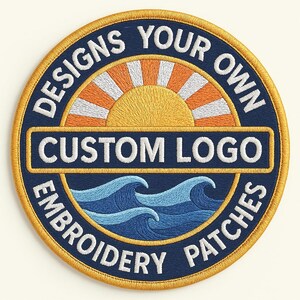 May include: Circular embroidered patch with a navy blue background and a gold border. The patch features a sunrise design with the text "DESIGNS YOUR OWN CUSTOM LOGO EMBROIDERY PATCHES" in white.