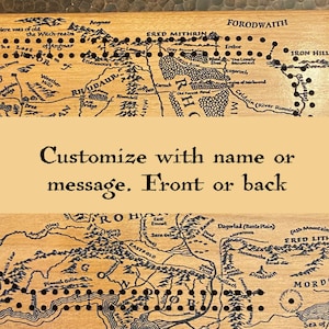 May include: Wooden cribbage board featuring a map design with black peg holes. The map includes text and geographical features. The board is customizable with a name or message on the front or back.