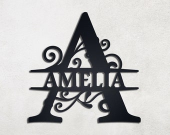 May include: Black metal monogram featuring the letter A with the name Amelia written across a double line below the letter.