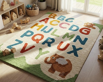 May include: A rectangular children's rug with a cream background and a green border. The rug features the alphabet in various colours and a cartoon elephant. The rug is designed for a child's room.