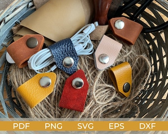 May include: Six leather cord organizers in various colors, including brown, blue, yellow, red, and pink. Each organizer has a metal button to secure cords.