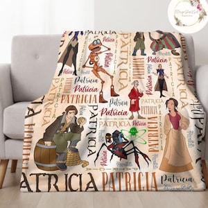 May include: A cream-coloured fleece blanket with a repeating pattern of the name "Patricia" in various fonts and colours. The blanket features cartoon characters from the animated film "The Princess and the Frog".
