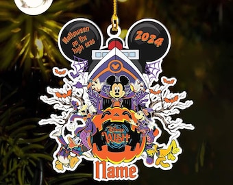 May include: A Halloween-themed ornament featuring Mickey Mouse and friends on a cruise ship. The design includes a pumpkin, bats, and the text "Halloween on the high seas 2024" and "Disney Wish". The ornament is suspended by a gold string.
