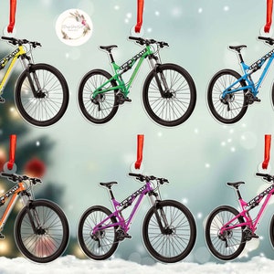 May include: Set of eight mountain bike ornaments, each featuring a different color: yellow, green, blue, orange, purple, pink, light blue, and black. The ornaments are made of metal and have a red ribbon for hanging.