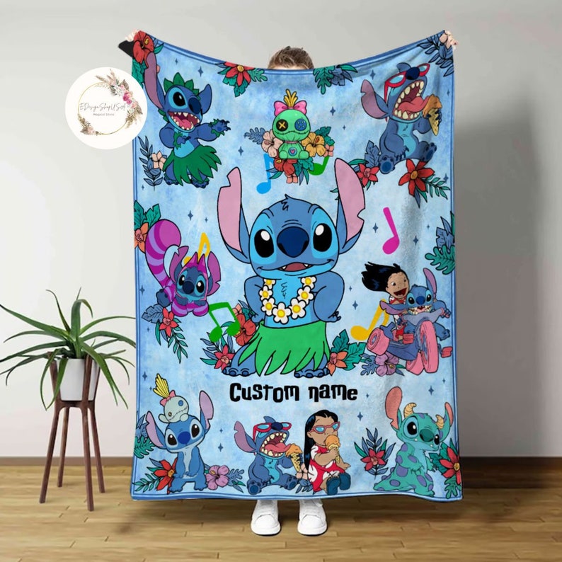 May include: A blue fleece blanket with a colorful design featuring Stitch from Lilo & Stitch. The blanket has a tropical theme with flowers, leaves, and musical notes. The text "Custom name" is printed on the blanket.