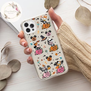 May include: Clear phone case with a Halloween-themed design featuring Mickey Mouse, Minnie Mouse, Donald Duck, and Goofy dressed in costumes and pumpkins. The case has a white background with black, orange, and pink accents.