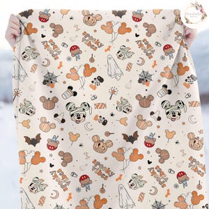 May include: A cream-colored fabric with a repeating pattern of Mickey Mouse characters in various Halloween costumes. The pattern also includes pumpkins, bats, candy, and the text "spooky vibes".