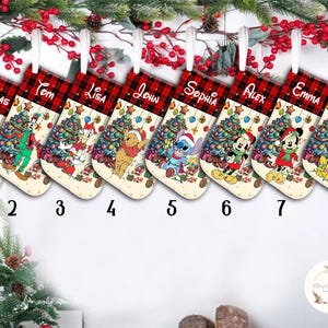 May include: Eight personalized Christmas stockings with red and black plaid trim. Each stocking features a different Disney character, including Mickey Mouse, Minnie Mouse, Donald Duck, Goofy, Winnie the Pooh, Stitch, and a Christmas tree. The stockings are labeled with the names Thomas, Tom, Lisa, John, Sophia, Alex, Emma, and Lucas.