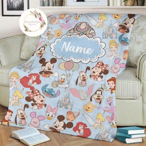May include: A blue fleece blanket with a Disney theme. The blanket features a variety of Disney characters, including Mickey Mouse, Minnie Mouse, Donald Duck, Goofy, and Pluto. The blanket also features the Disney castle and other Disney-themed imagery. The blanket is personalized with the name "Name".