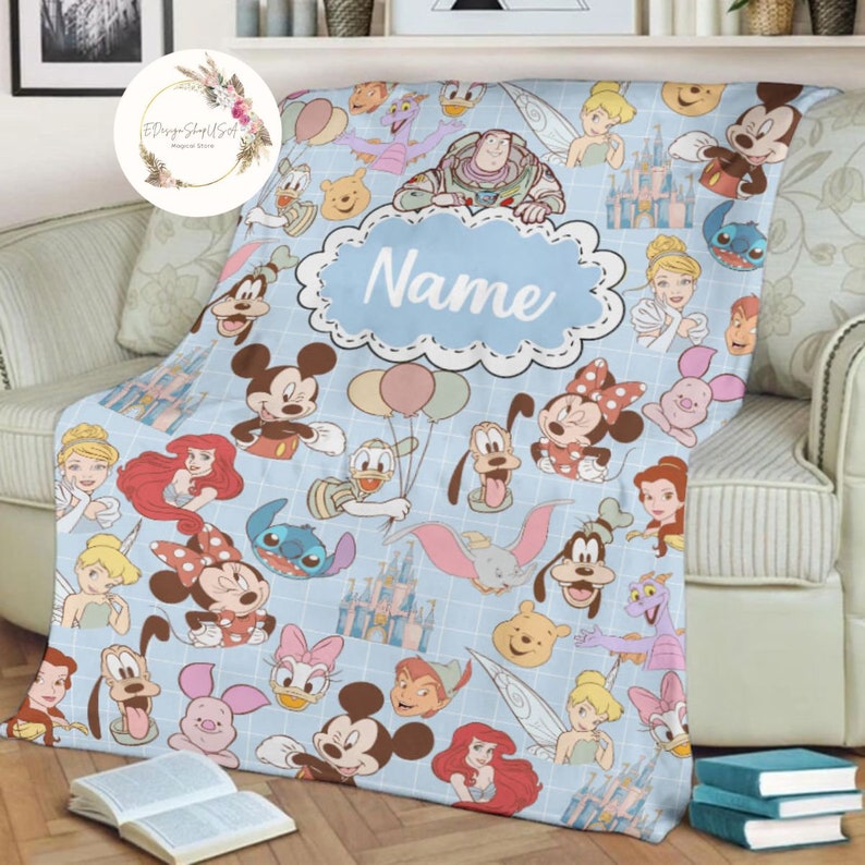 May include: A blue fleece blanket with a Disney theme. The blanket features a variety of Disney characters, including Mickey Mouse, Minnie Mouse, Donald Duck, Goofy, and Pluto. The blanket also features the Disney castle and other Disney-themed imagery. The blanket is personalized with the name "Name".