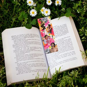 May include: A colourful bookmark featuring a disco ball design and images of people. The bookmark is placed on an open book with text in Italian.