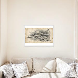 May include: A framed black and white illustration of a fighter jet. The detailed drawing shows the jet's components, with labels such as "Control System" and "Radar". The artwork is on aged paper, giving it a vintage aesthetic.