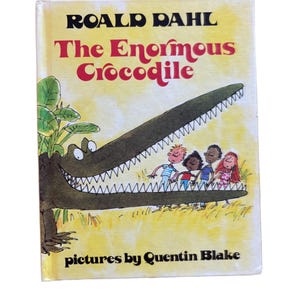 May include: A well-loved copy of Roald Dahl's "The Enormous Crocodile", illustrated by Quentin Blake. The cover shows a green crocodile with children in its mouth. The title is in red, with the author's name in black. A classic children's book.