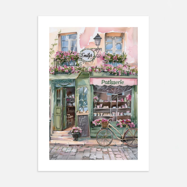 May include: A watercolour painting of a French bakery called "Emily's Patisserie". The shop front is painted in shades of green and pink with a bicycle parked outside. The bakery has a sign that says "Patisserie" and a window display filled with pastries.