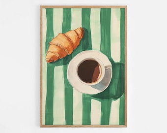 May include: A top-down view of a cup of coffee and a croissant on a green and white striped tablecloth. The coffee is in a white cup and saucer, and the croissant is golden brown.