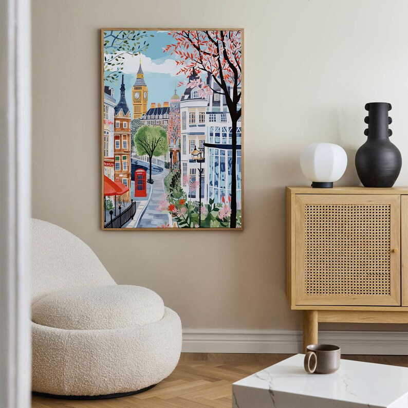 May include: A colorful illustration of a London street scene with Big Ben in the background. The street is lined with buildings and trees, and there is a red telephone booth in the foreground.