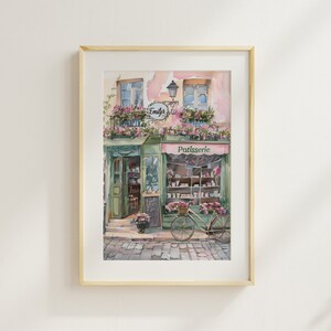 May include: A watercolour painting of a French bakery storefront with a green awning that says "Patisserie". The bakery is called "Emily's" and has a bicycle parked in front of it.