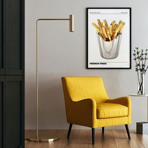May include: A black and white poster with a gold french fry illustration in a silver container. The poster has the text "French Fries" at the bottom.