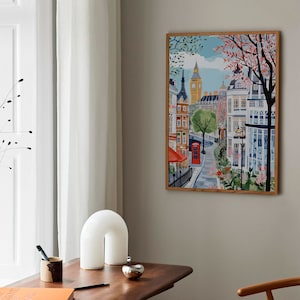 May include: A colorful illustration of a street scene in London, England. The image features Big Ben, a red telephone booth, and a cafe with a red awning. The street is lined with buildings and trees.