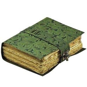 May include: A green leather journal with a floral embossed design. The journal has a strap closure with a metal clasp. The pages are aged and have a deckled edge. The journal is a handmade item.