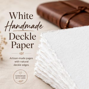 May include: A stack of white handmade deckle paper with natural deckle edges. The paper is artisan-made and has a textured surface. The image also shows a brown leather journal in the background. Text on the image reads "White Handmade Deckle Paper."