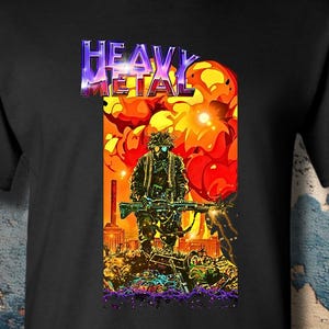 May include: A black short-sleeved t-shirt featuring a graphic print of a soldier holding a rifle in front of a large orange explosion. The text HEAVY METAL is printed in a metallic purple and blue font above the soldier, set against a dark background.
