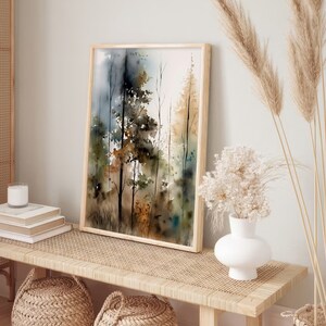 May include: A framed watercolor painting of a forest scene with trees in shades of brown, green, and blue. The painting is hanging on a wall above a wooden bench with woven cushions.