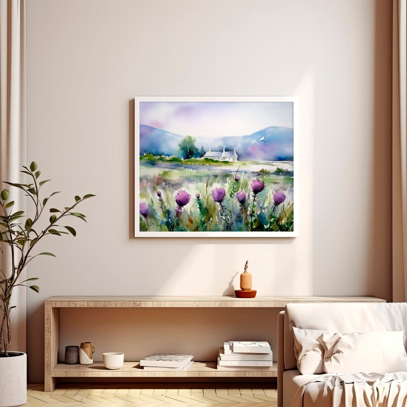 May include: Watercolor painting of a white cottage in a field of purple wildflowers with a mountain range in the background.