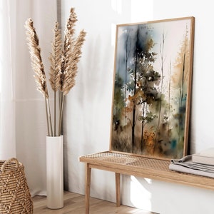May include: A framed watercolor painting of a forest scene with tall trees in shades of brown, green, and blue. The painting has a soft, dreamy feel and is perfect for adding a touch of nature to any room.