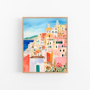 May include: A watercolor painting of a colorful Italian village with a blue ocean in the background. The buildings are painted in shades of pink, yellow, orange, and red. There are trees and flowers in the foreground.
