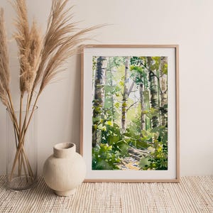 May include: A framed watercolor painting of a forest scene with tall trees and green foliage. The painting is in a light wood frame and is hanging on a white wall.