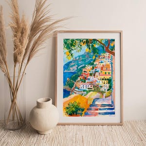 May include: Watercolour painting of a coastal Italian village with colourful buildings cascading down a hillside. The artwork features a vibrant palette of blues, yellows, oranges, and greens, with a tree in the upper right corner.