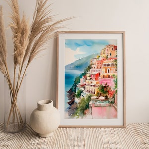 May include: A watercolour painting depicting a colourful Italian village perched on a cliff overlooking the sea. The buildings are painted in shades of pink, yellow, orange, and red. The sea is a deep blue, and the sky is a light blue with white clouds.