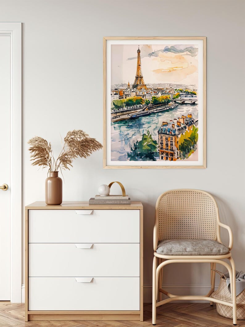 Puede incluir: Una pintura de acuarela de la Torre Eiffel en Par&iacute;s, Francia. La pintura muestra la torre desde la distancia, con el r&iacute;o Sena y otros edificios en primer plano. El cielo es de un azul claro con algunas nubes.