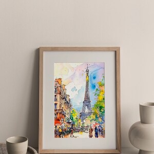 Puede incluir: Una pintura de acuarela de la Torre Eiffel en Par&iacute;s, Francia. La pintura muestra una escena de calle con gente caminando y un caf&eacute; en primer plano. La Torre Eiffel est&aacute; en el fondo, con un cielo azul y nubes arriba.