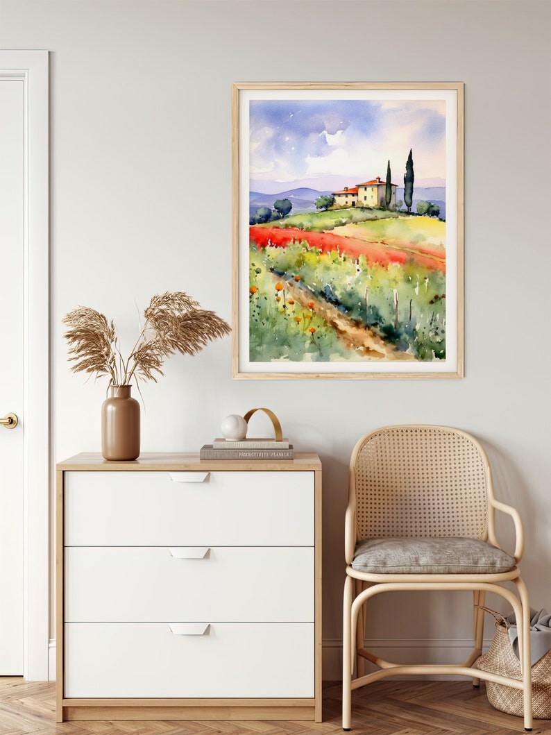 May include: Watercolor painting of a house on a hill with a field of red flowers in the foreground. The house has a red roof and is surrounded by green trees. The sky is blue with white clouds.