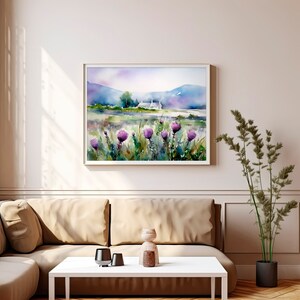 May include: A watercolor painting of a white cottage in a field of purple wildflowers with a mountain range in the background.