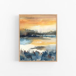May include: Abstract watercolor painting of a landscape with a yellow, orange, and blue color scheme. The painting depicts a lake with a forest in the background and a sunset sky.